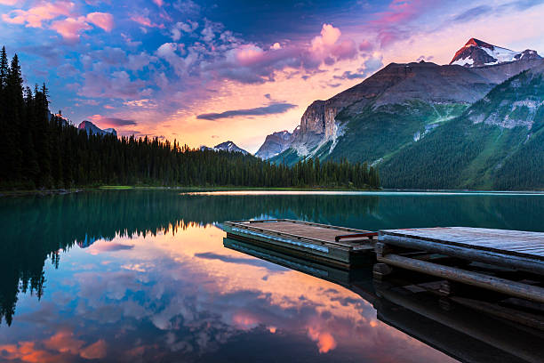 Kayaks on a clear lake in the Canadian Rockies